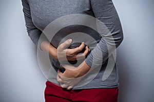 Woman has stomachache over white background