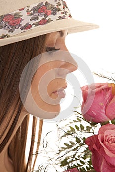 Woman hat close smell roses