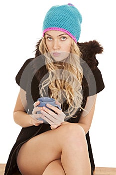 Woman hat coat mug look serious