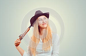 Woman in hat with double-barreled gun thinking photo