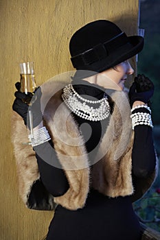 Woman in hat, fur and champagne