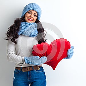 Woman in hat holding heart