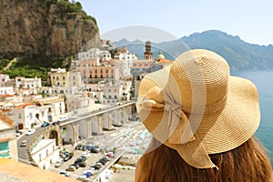 Woman with hat looking at typical italian landscape of Atrani village, Amalfi Coast, Italy