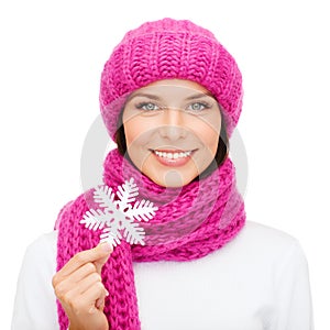Woman in hat and muffler with big snowflake
