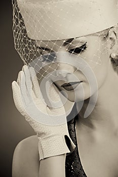 Woman in hat with net veil