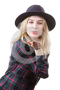 Woman in hat sending air kiss