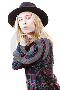 Woman in hat sending air kiss