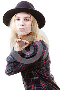 Woman in hat sending air kiss