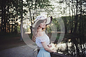 Woman in a hat in a spring park