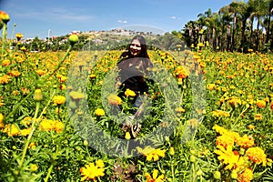 Woman with hat walks in cultivation field of Cempasuchil flower, flower for day of the dead in Mexico