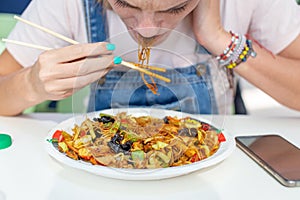 Woman hates eating chinese noodles in restaurant