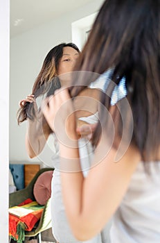 Woman have damaged and broken hair, loss hair, dry problem concept. Asian woman in living room after shower.