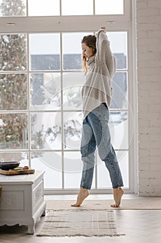 Woman have fun dancing near window