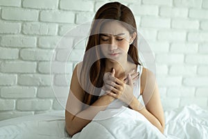 Woman have a heart attack in chest pain after wake up in the morning,Healthcare Concept