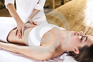 Woman having abdomen massage.