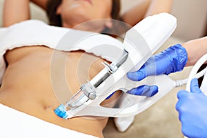 Woman having abdomen mesotherapy in beauty salon