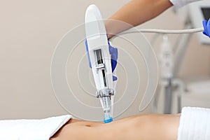 Woman having abdomen mesotherapy in beauty salon
