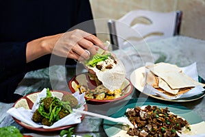 Woman having Arabic food in a restaurant