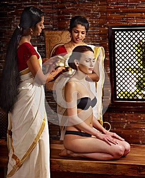 Woman having ayurveda spa treatment.