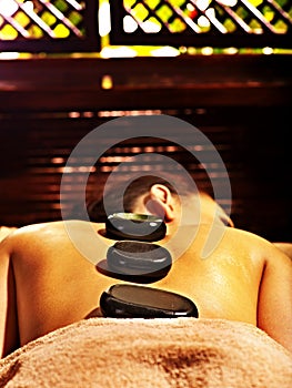 Woman having Ayurvedic stone massage.
