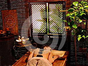 Woman having Ayurvedic stone massage