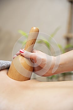 Maderotherapy massage with wooden swedish cup photo
