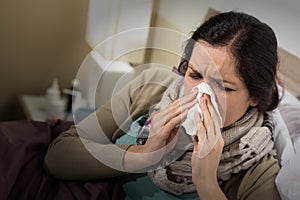 Woman having bad cold blowing her nose