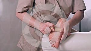 Woman having bamboo sticks massage