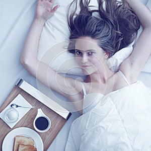 Woman having breakfast in bed