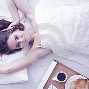 Woman having breakfast in bed