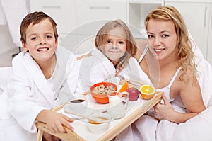 Woman having breakfast in bed with the kids