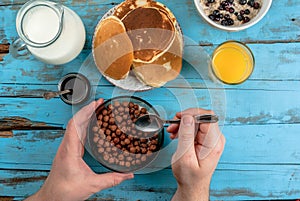 Woman having breakfast with cereal chocolate balls