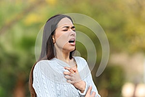 Woman having breath problems in a park