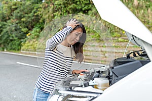 Woman having car problem at road