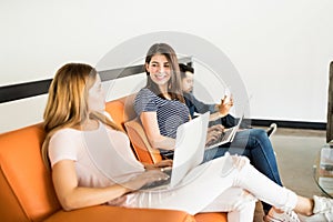 Woman having casual talk in office lounge