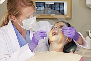 Woman Having Check Up At Dentists Surgery