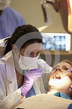 Woman Having Check Up At Dentists Surgery