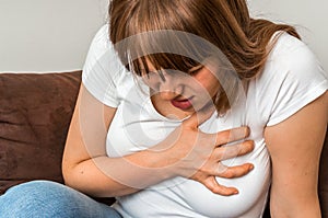 Woman having chest pain, heart attack