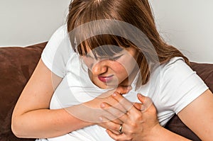 Woman having chest pain, heart attack