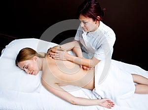 Woman having chiropractic back adjustment