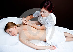 Woman having chiropractic back adjustment photo