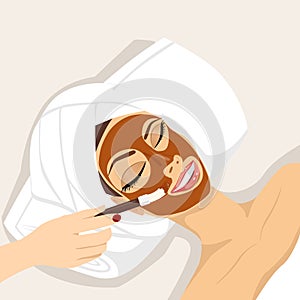 Woman having chocolate mask treatment therapy