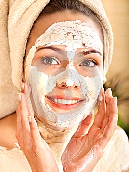 Woman having clay body mask.