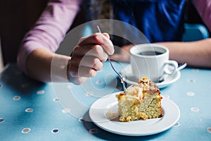 Woman having coffee and cake in tearoom