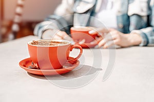 woman having coffee at street cafe with friend outside, having fun time. lifestyle concept