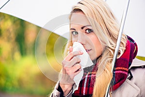 Woman having cold or flu due to bad autumn weather