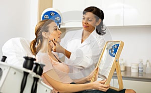 Woman having consultation at aesthetic medicine clinic