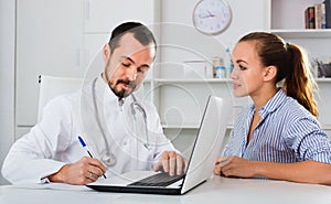 Woman having consultation with male doctor in hospital