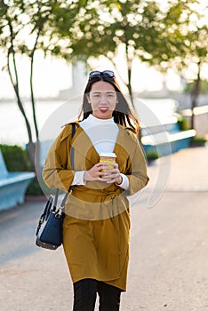 Woman having a cup of coffee outdoors