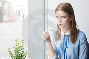 Woman having a cup of mocca in cafe photo
